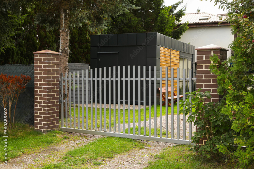 Grey metal gates near private house on street Grey metal gates near private house on street