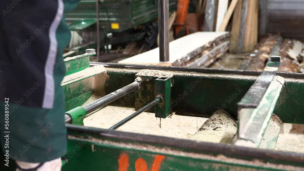 Person preparing support for log cutting in sawmill, close up view Person preparing support for log cutting in sawmill, close up view