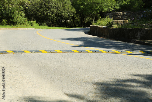 Photography Speed bump on asphalt road near trees outdoors
