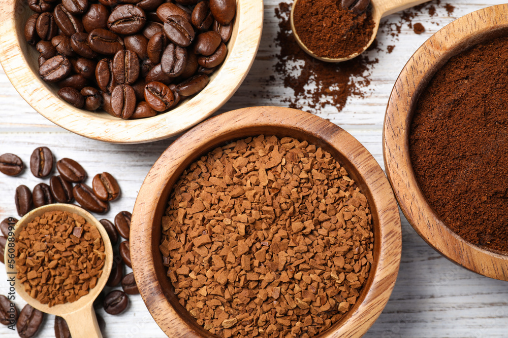 Instant, ground coffee and roasted beans on white wooden table, flat lay Instant, ground coffee and roasted beans on white wooden table, flat lay