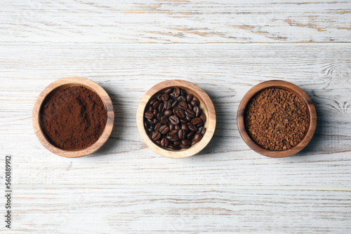 Instant, ground coffee and roasted beans on white wooden table, flat lay