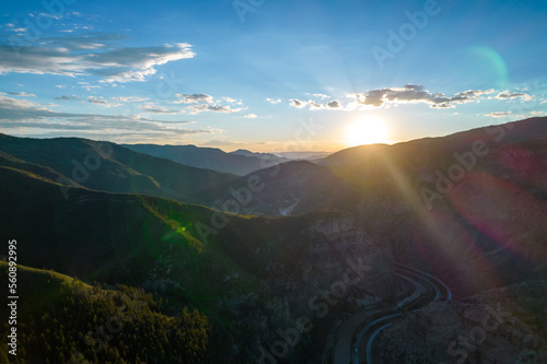 Aerial view of sunset in canyon with highway along small river.Landscape in the west.