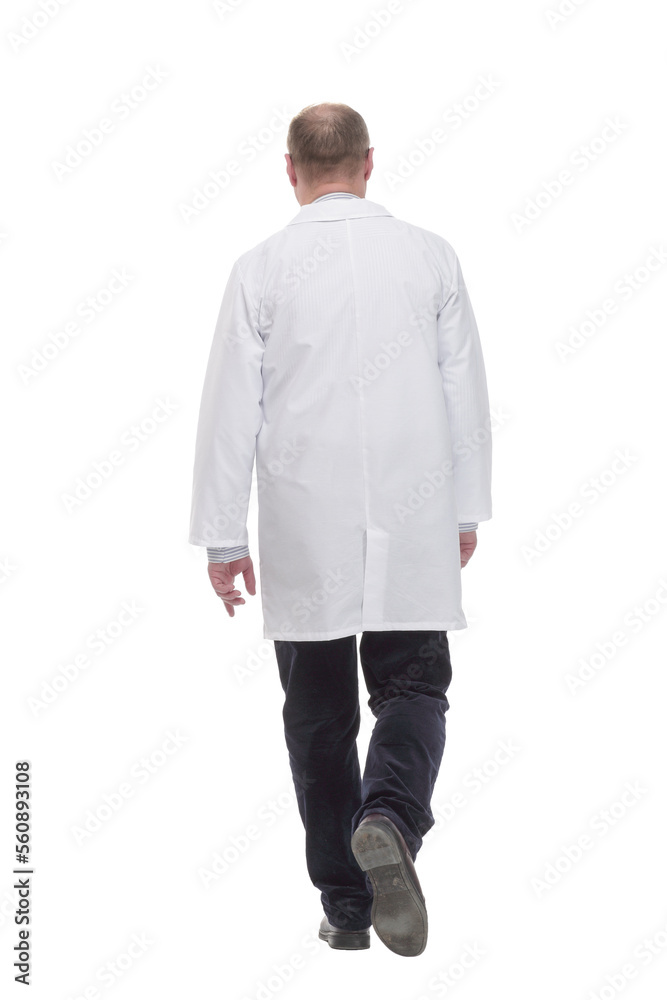 mature doctor in a white coat striding forward