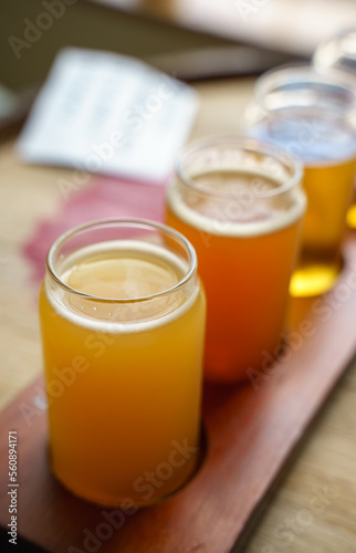 Fototapeta Naklejka Na Ścianę i Meble -  A flight of beer. Beer flights are small servings of various beers. They come in anywhere from 4-8 varieties depending on the brewery. Usually, customers will receive a small 3 – 5 oz. glass