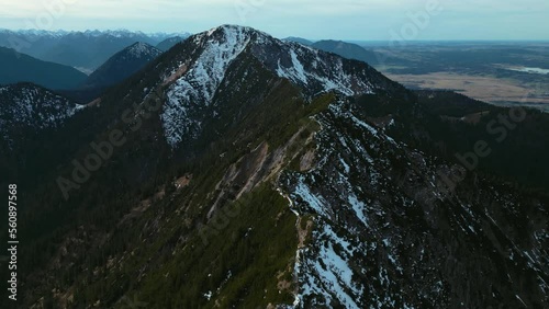 Cinematic drone aerial at Herzogstand mountain top peak. Bavarian Alps mountains next to Lake Walchensee and Kochelsee and Alpine Foothills. Hiking climbing, scenic point of view in 4K. Epic landscape photo