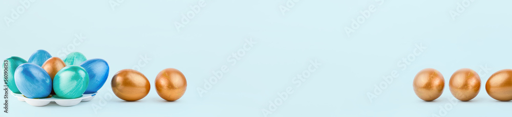 Colorful easter eggs on blue background with copy space