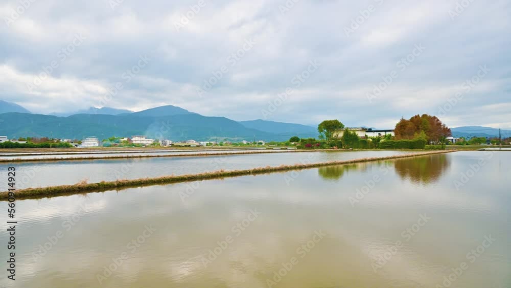 Beautiful countryside landscape at dusk. House, water field and mountain. Dongshan River Water Park. Sanxing Township, Yilan County, Taiwan