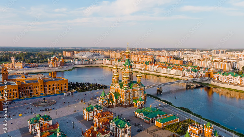 Yoshkar-Ola, Russia - September 25, 2022: Cathedral of the Annunciation of the Blessed Virgin in Yoshkar-Ola. City Center during sunset. Embankment of the river, Aerial View