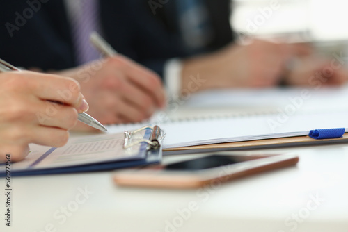 Closeup of people make up forms during business conference