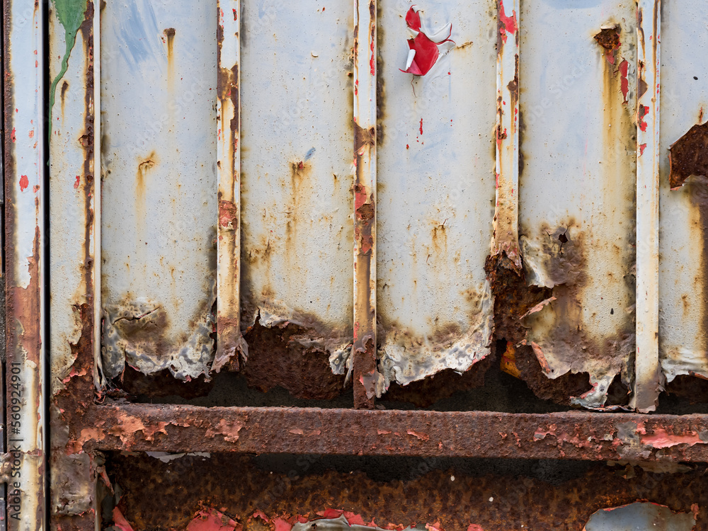 wall or surface of a fence of metal, with orange grooves from rust and irregular chipping. wall or surface of a fence of metal, with orange grooves from rust and irregular chipping.