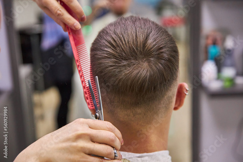 barber cutting hair with scissors. Haircut service. Man hairstyle