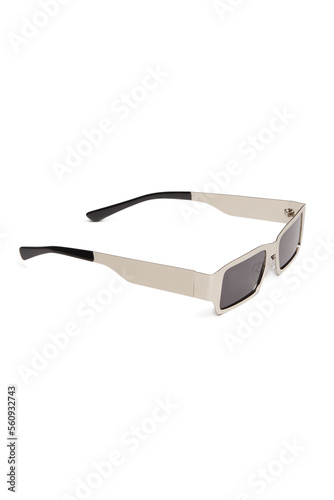 Close-up shot of sunglasses with black lenses and a silver-coloured metal frame. Rectangular sunglasses are isolated on a white background. Side view.