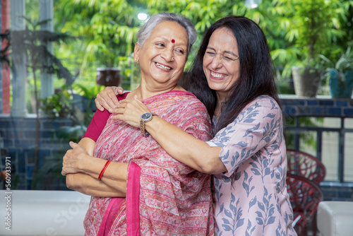 Fotografiet Portrait of happy young indian daughter hug her mother at home, Love and bonding, Asian family