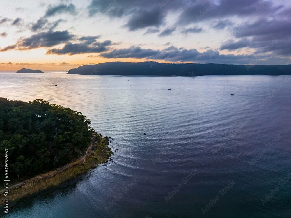 Sunrise views over the bay with boats and mountain ranges from Patonga