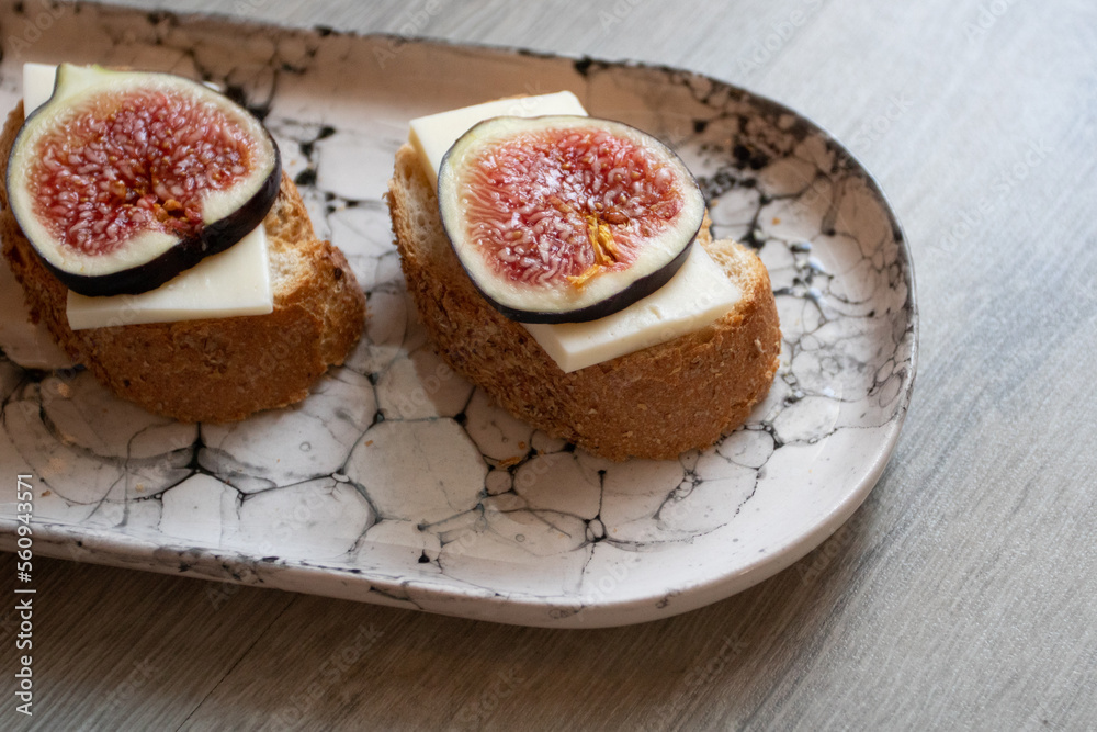 Sandwich with figs and cheese on a marble plate Sandwich with figs and cheese on a marble plate