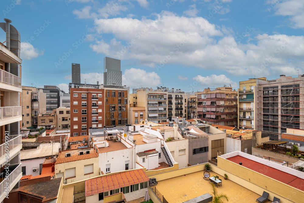 View of typical inner courtyard in the Eixample district, Barcelona, Catalonia, Spain on cloudy day with blue sky.