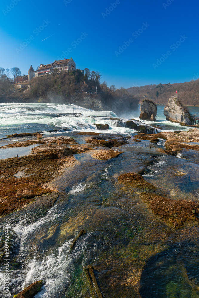 Rhine Falls or Rheinfall, Switzerland panoramic view. Tourist boat in waterfall. Bridge and border between the cantons Schaffhausen and Zürich. The Largest waterfall in Europe.