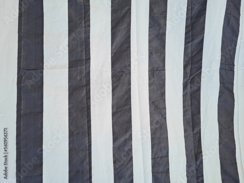 evocative textured image of a fabric with a blue and white vertical striped pattern 