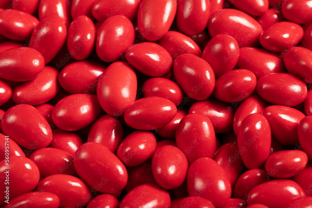 Chocolate dragee in the form of a pile. Red dragee chocolate with chocolate filling. close up Chocolate dragee in the form of a pile. Red dragee chocolate with chocolate filling. close up
