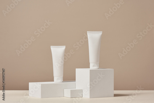 Unbranded blank cosmetics packages on a pedestal. Skincare female products