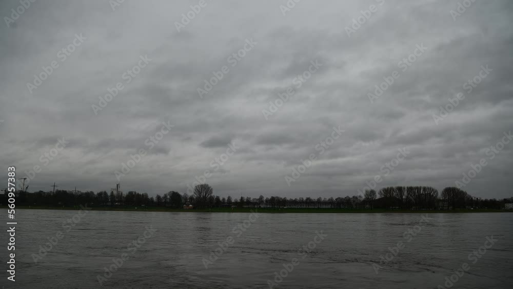 COLOGNE, GERMANY - JANUARY 12, 2023: Rhein in Cologne, flooded. Rhine water level. Low exposure COLOGNE, GERMANY - JANUARY 12, 2023: Rhein in Cologne, flooded. Rhine water level. Low exposure