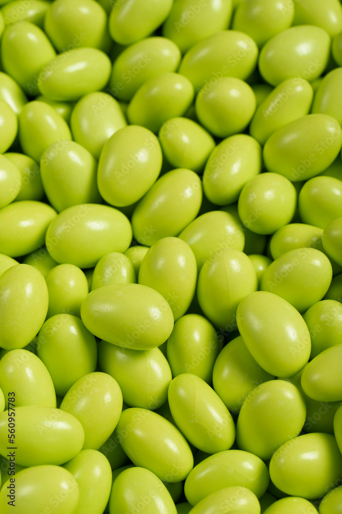 Chocolate dragee in the form of a pile. Green dragee chocolate covered with sugar on the outside and filled with chocolate inside. Close up Chocolate dragee in the form of a pile. Green dragee chocolate covered with sugar on the outside and filled with chocolate inside. Close up