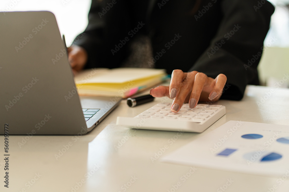 Hand of a business man using a calculator to check financial accounts, check expenditures and company budget. Female accountant calculating while working analyzing business reports at work Hand of a business man using a calculator to check financial accounts, check expenditures and company budget. Female accountant calculating while working analyzing business reports at work