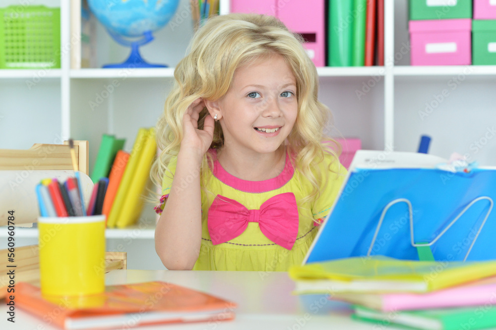 little girl studying at home at the table little girl studying at home at the table