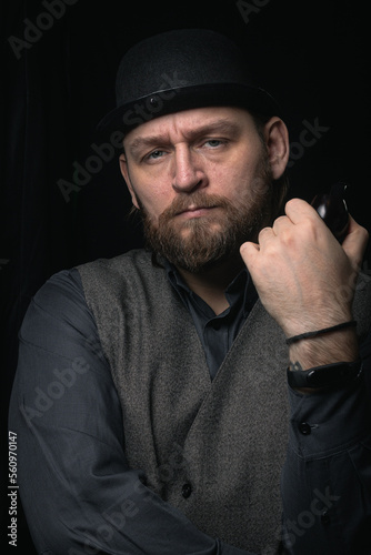 stylish man in retro outfit suit hat smoking wooden pipe sherlock holmes look cosplay england gentleman fashionable confident gangster Guy Ritchie Charlie Hunnam style