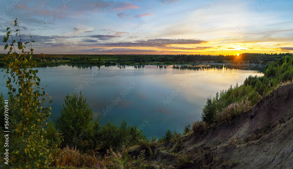 Sunset over the horizon and at the water quarry . Leningrad region. Vsevolozhsk.