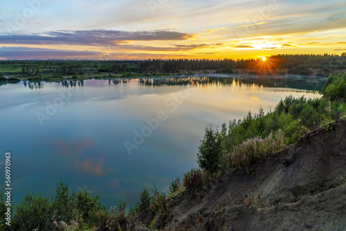 Sunset over the horizon and at the water quarry . Leningrad region. Vsevolozhsk.