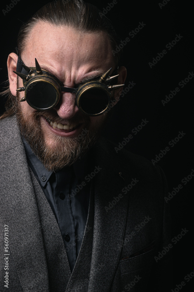 charismatic man in a classic suit and steampunk goggles on a black background stylish Portrait charismatic man in a classic suit and steampunk goggles on a black background stylish Portrait