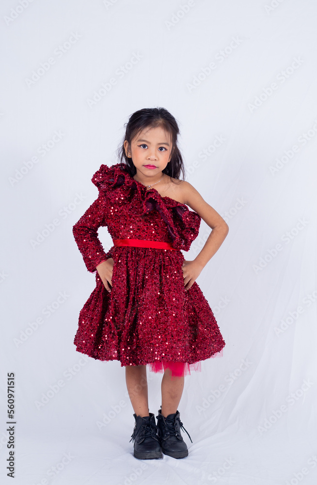 A portrait of kid model dressing red isolated on white background. Adorable asian girl posing in style. A portrait of kid model dressing red isolated on white background. Adorable asian girl posing in style.