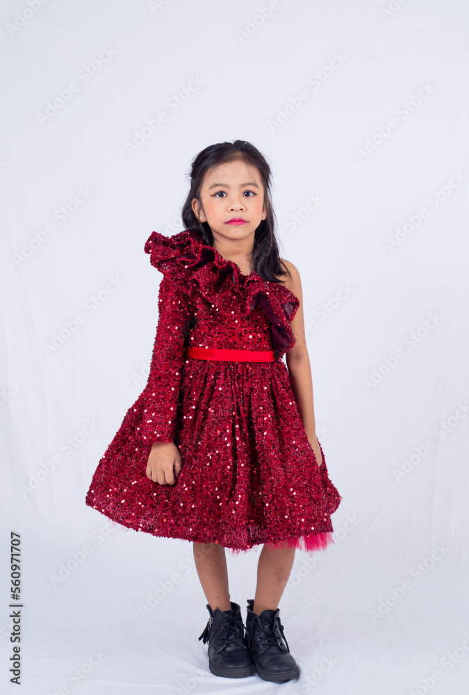 Little model girl isolated on white background. Asian child wearing red dress and posing in studio. Little model girl isolated on white background. Asian child wearing red dress and posing in studio.