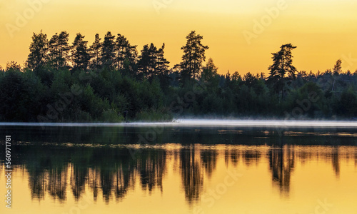 Misty haze over the water during sunset. © amarinchenko106