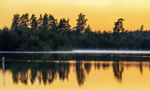 Misty haze over the water during sunset.