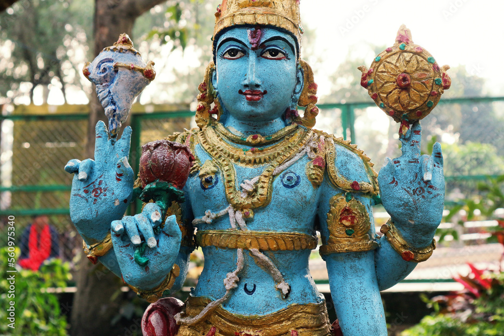 Lord Vishnu or Narayana with four arms and attributes close up.