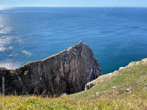 Trail along the edge of the cliff on the island of Shkota in September in sunny weather. Russia, Vladivostok city photo