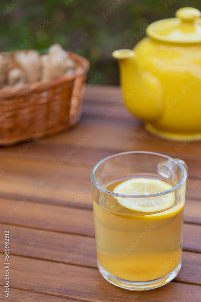 Tea with lemon and ginger on a rustic wooden table. Strengthen your immune system. Alternative medicine. Wellness and health. Tea with lemon and ginger on a rustic wooden table. Strengthen your immune system. Alternative medicine. Wellness and health.