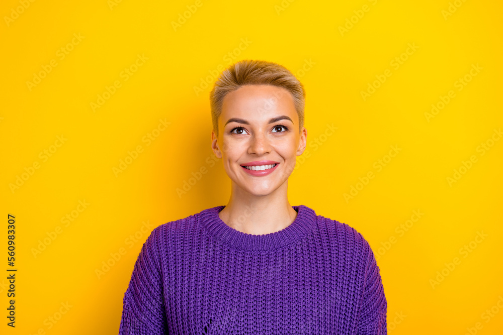 Closeup photo of smile positive good mood blonde short hair lady wear purple pullover look up good news promo isolated on yellow color background Closeup photo of smile positive good mood blonde short hair lady wear purple pullover look up good news promo isolated on yellow color background