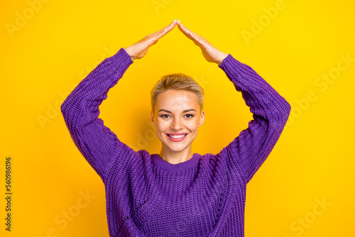 Photo of lovely positive lady arm make roof under head dream own flat office city center isolated on yellow color background © deagreez