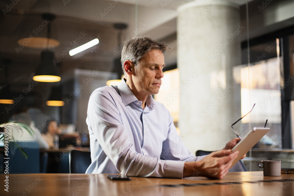 Portrait of businessman in office. Man using digital tablet. Businessman having video call. Portrait of businessman in office. Man using digital tablet. Businessman having video call.
