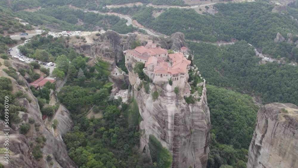 Aerial view away from the Varlaam cloister, in Meteora, Greece - pull back, drone shot Aerial view away from the Varlaam cloister, in Meteora, Greece - pull back, drone shot