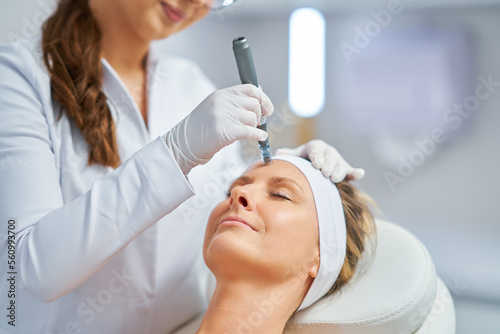 Woman in a beauty salon having needle mesotherapy treatment