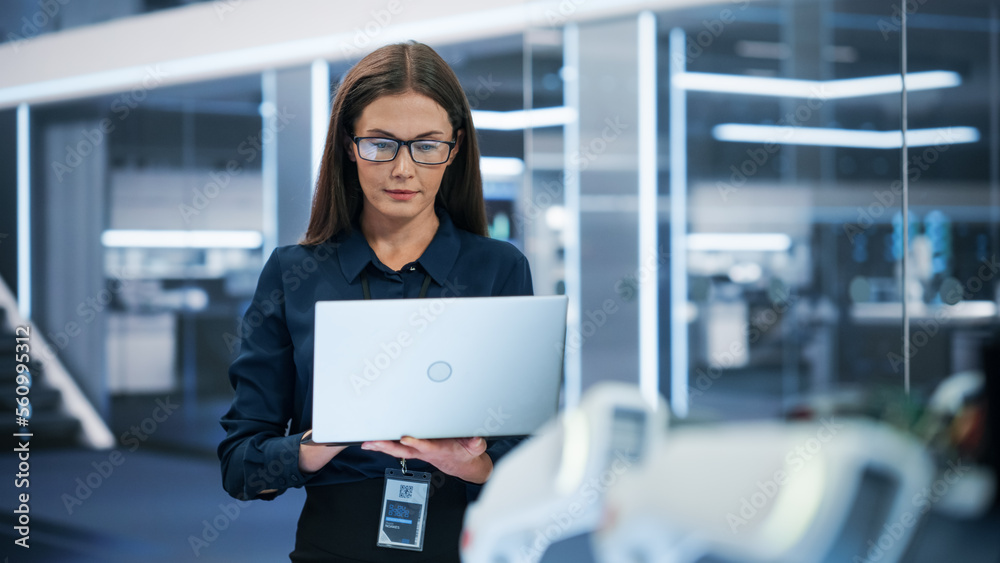 Portrait of a Beautiful Caucasian Female Wearing Smart Corporate Attire and Glasses, Using Laptop Computer. Businesswoman, Information Technology Manager, Robotics Engineering Specialist. - obrazy, fototapety, plakaty 