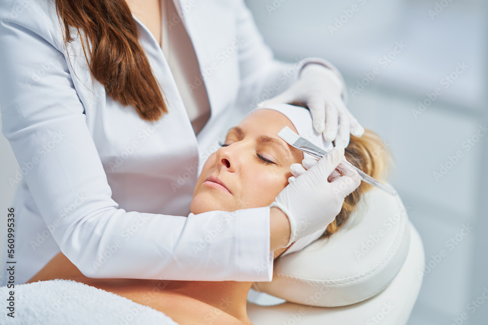 Woman in a beauty salon having face and body treatment