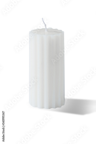 Subject shot of a figured white candle with a wavy surface. The designer handmade candle is isolated on the white background.