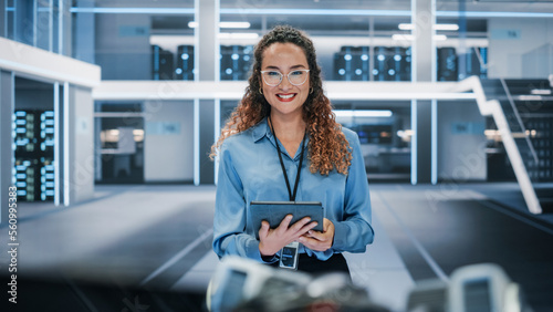 Portrait of a Beautiful Latin Female Wearing Smart Corporate Shirt and Glasses, Looking at Camera and Smiling. Businesswoman, Information Technology Manager, Robotics Engineering Specialist.