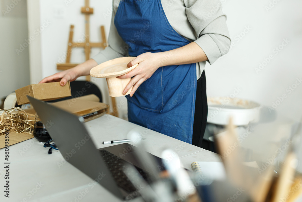 Unrecognisable woman entrepreneur, Business owner working at home office with her clay ceramic product. Online selling business work