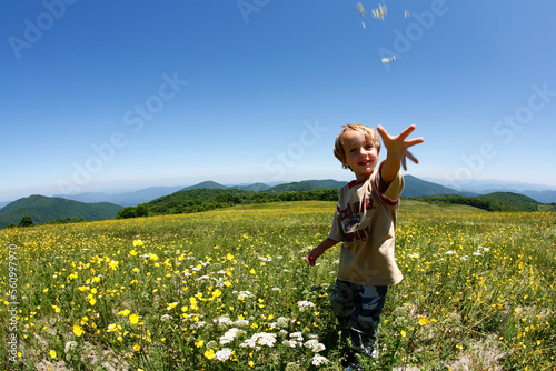 Hank Igelman throws some wildflowers at the camera along the Appalachian Trail atop Max Patch Bald west of Asheville, NC photo